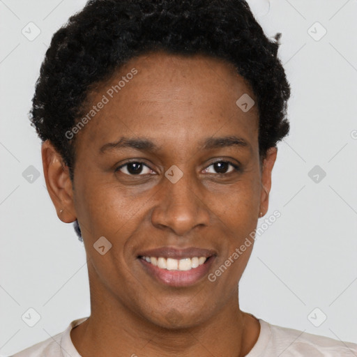 Joyful black young-adult female with short  brown hair and brown eyes