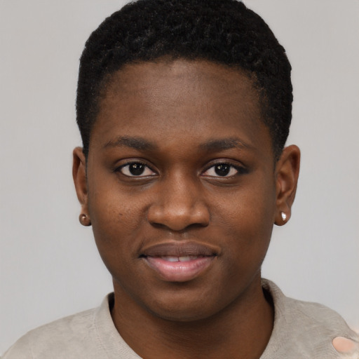 Joyful black young-adult female with short  black hair and brown eyes
