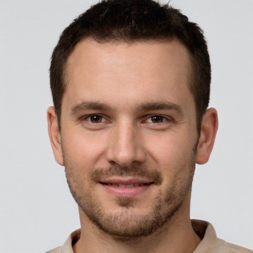 Joyful white young-adult male with short  brown hair and brown eyes