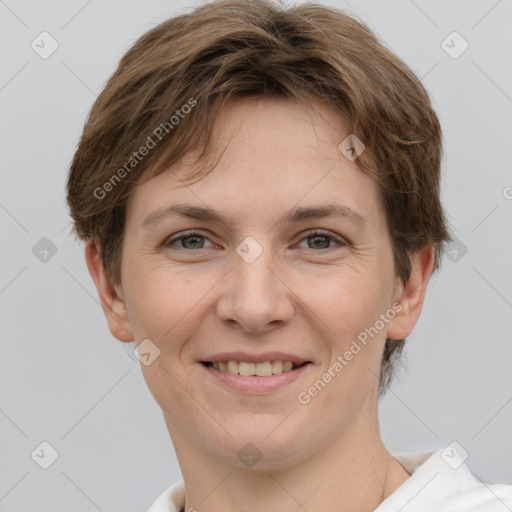 Joyful white young-adult female with short  brown hair and grey eyes