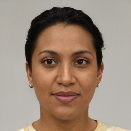 Joyful latino young-adult female with short  black hair and brown eyes