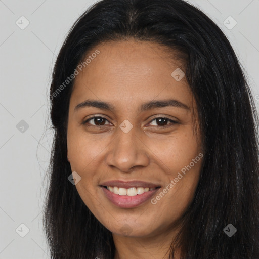 Joyful black young-adult female with long  brown hair and brown eyes