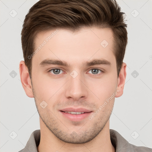 Joyful white young-adult male with short  brown hair and grey eyes