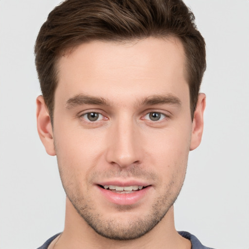 Joyful white young-adult male with short  brown hair and brown eyes