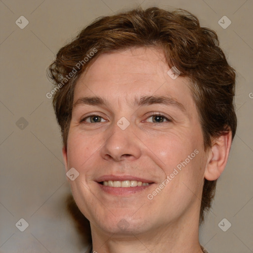 Joyful white adult male with medium  brown hair and brown eyes