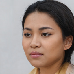 Joyful asian young-adult female with long  brown hair and brown eyes