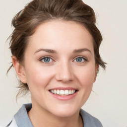 Joyful white young-adult female with medium  brown hair and blue eyes