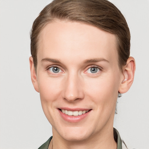 Joyful white young-adult female with short  brown hair and grey eyes