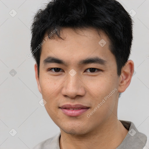 Joyful asian young-adult male with short  black hair and brown eyes