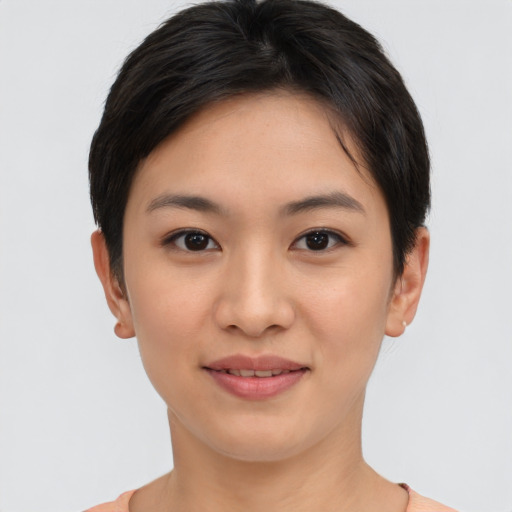 Joyful asian young-adult female with short  brown hair and brown eyes