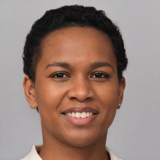 Joyful black young-adult female with short  brown hair and brown eyes