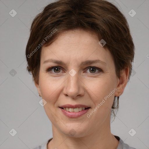 Joyful white adult female with short  brown hair and grey eyes