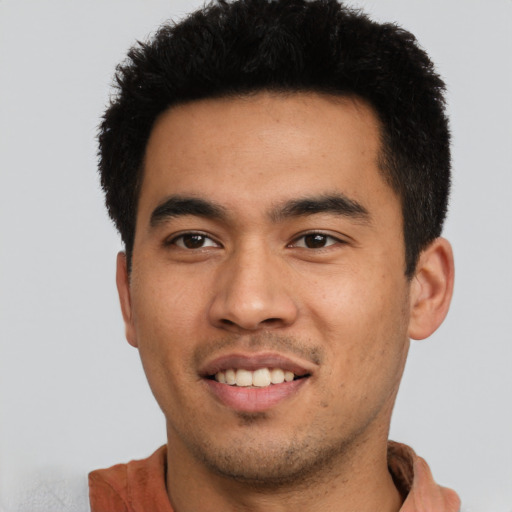 Joyful asian young-adult male with short  black hair and brown eyes