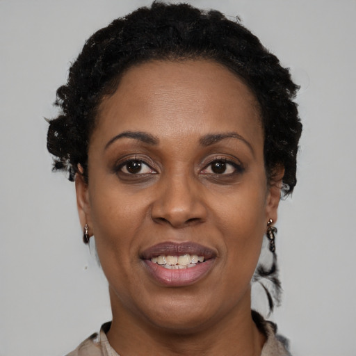 Joyful black adult female with short  black hair and brown eyes