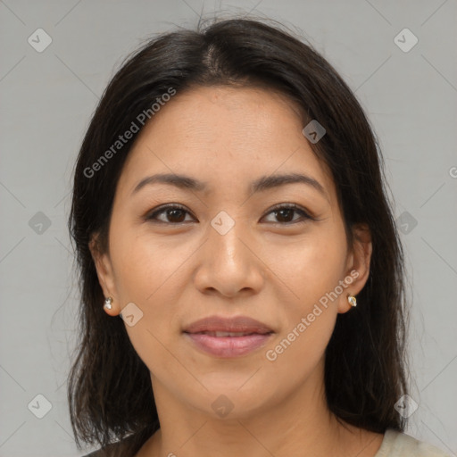 Joyful latino young-adult female with medium  brown hair and brown eyes