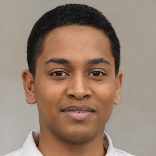 Joyful black young-adult male with short  brown hair and brown eyes