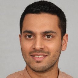 Joyful white young-adult male with short  black hair and brown eyes