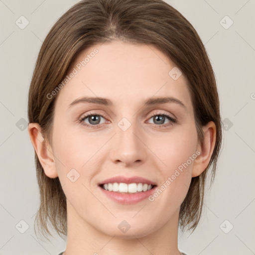 Joyful white young-adult female with medium  brown hair and green eyes