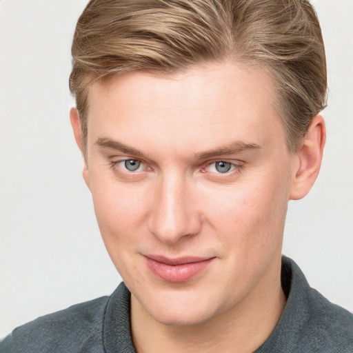 Joyful white young-adult male with short  brown hair and blue eyes