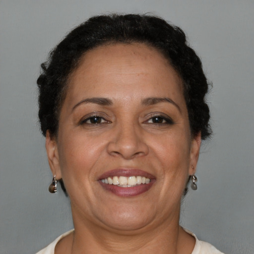 Joyful latino adult female with short  brown hair and brown eyes