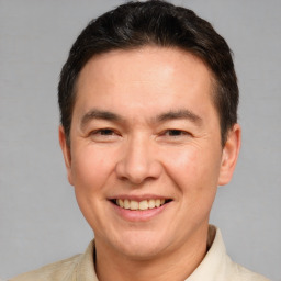 Joyful white adult male with short  brown hair and brown eyes