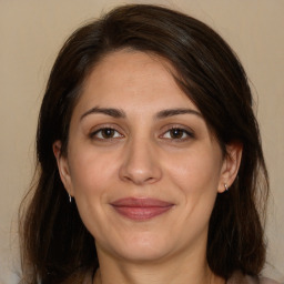 Joyful white adult female with medium  brown hair and brown eyes