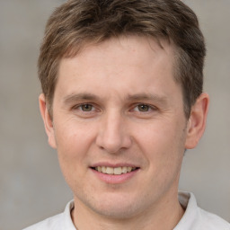 Joyful white adult male with short  brown hair and brown eyes