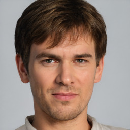 Joyful white young-adult male with short  brown hair and grey eyes