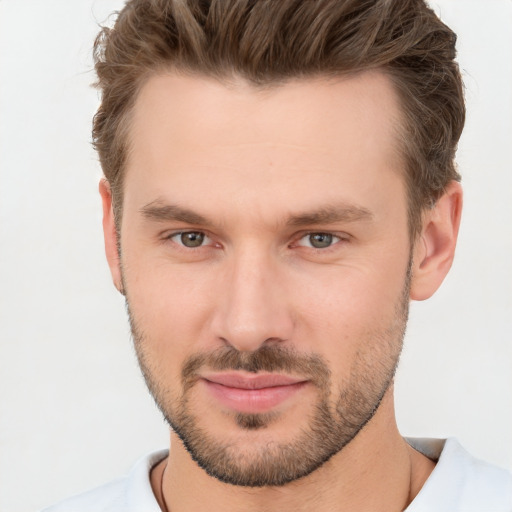 Joyful white young-adult male with short  brown hair and brown eyes