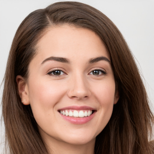 Joyful white young-adult female with long  brown hair and grey eyes