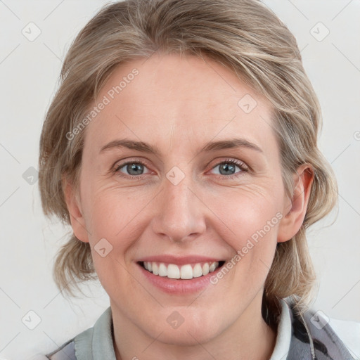 Joyful white young-adult female with medium  brown hair and blue eyes