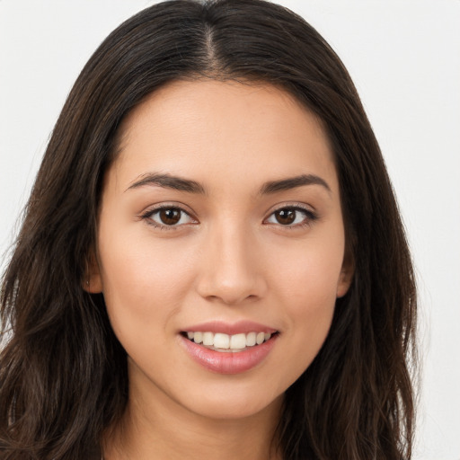 Joyful white young-adult female with long  brown hair and brown eyes