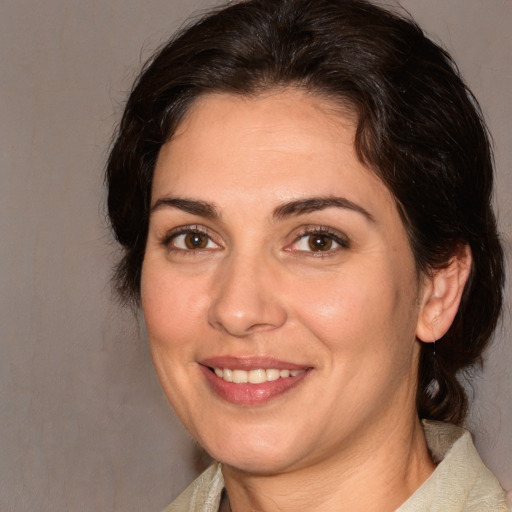 Joyful white adult female with medium  brown hair and brown eyes