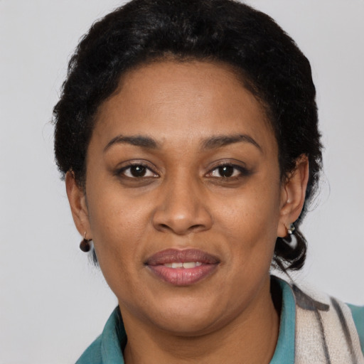 Joyful latino young-adult female with short  black hair and brown eyes