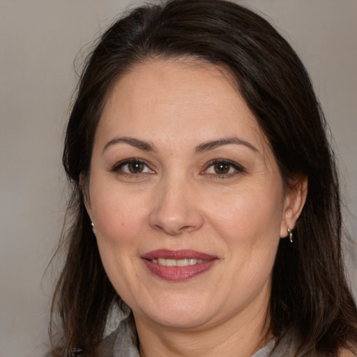 Joyful white adult female with medium  brown hair and brown eyes