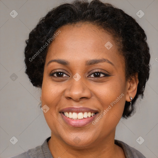 Joyful black adult female with short  brown hair and brown eyes