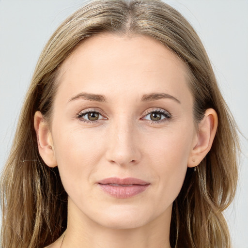 Joyful white young-adult female with long  brown hair and blue eyes