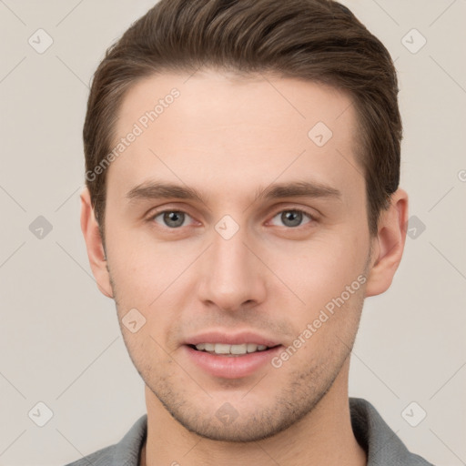 Joyful white young-adult male with short  brown hair and grey eyes