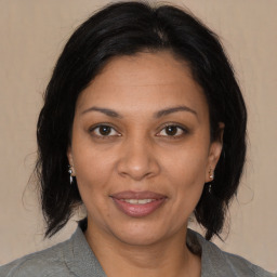 Joyful black adult female with medium  brown hair and brown eyes