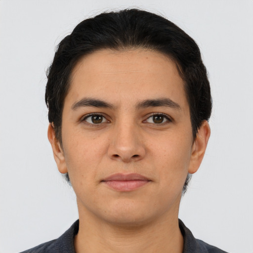 Joyful latino young-adult male with short  brown hair and brown eyes