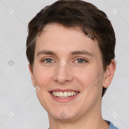 Joyful white young-adult female with short  brown hair and grey eyes