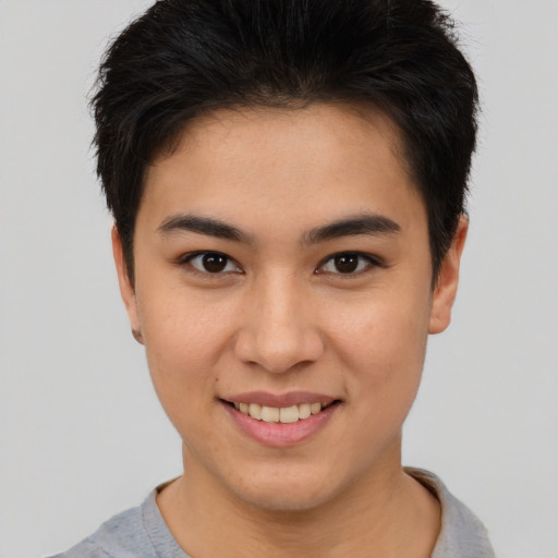 Joyful asian young-adult female with short  brown hair and brown eyes