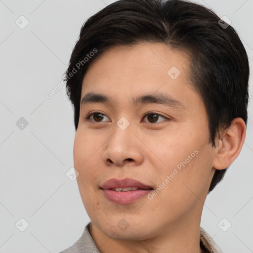 Joyful asian young-adult male with short  brown hair and brown eyes