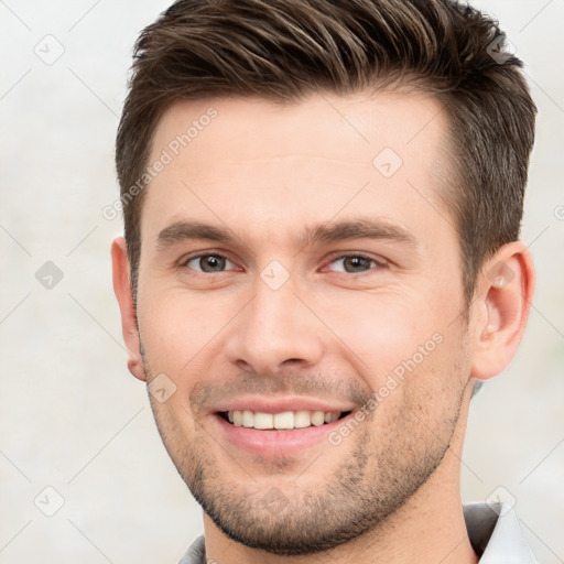 Joyful white young-adult male with short  brown hair and brown eyes