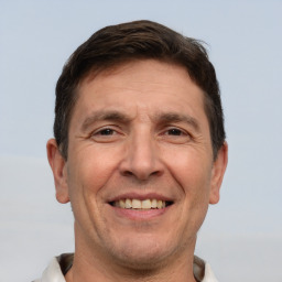 Joyful white adult male with short  brown hair and brown eyes