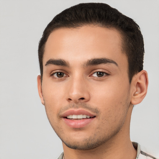 Joyful white young-adult male with short  black hair and brown eyes