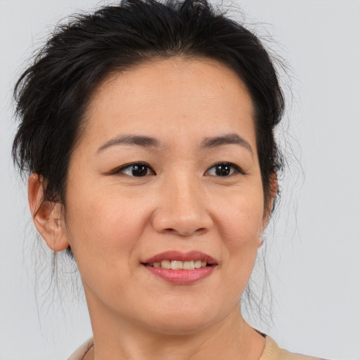 Joyful asian adult female with medium  brown hair and brown eyes