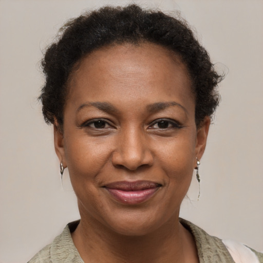 Joyful black adult female with short  brown hair and brown eyes