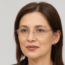 Joyful white adult female with long  brown hair and brown eyes