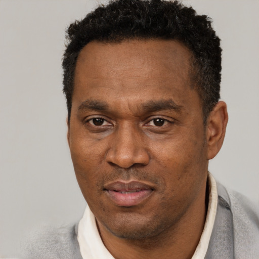 Neutral black adult male with short  black hair and brown eyes